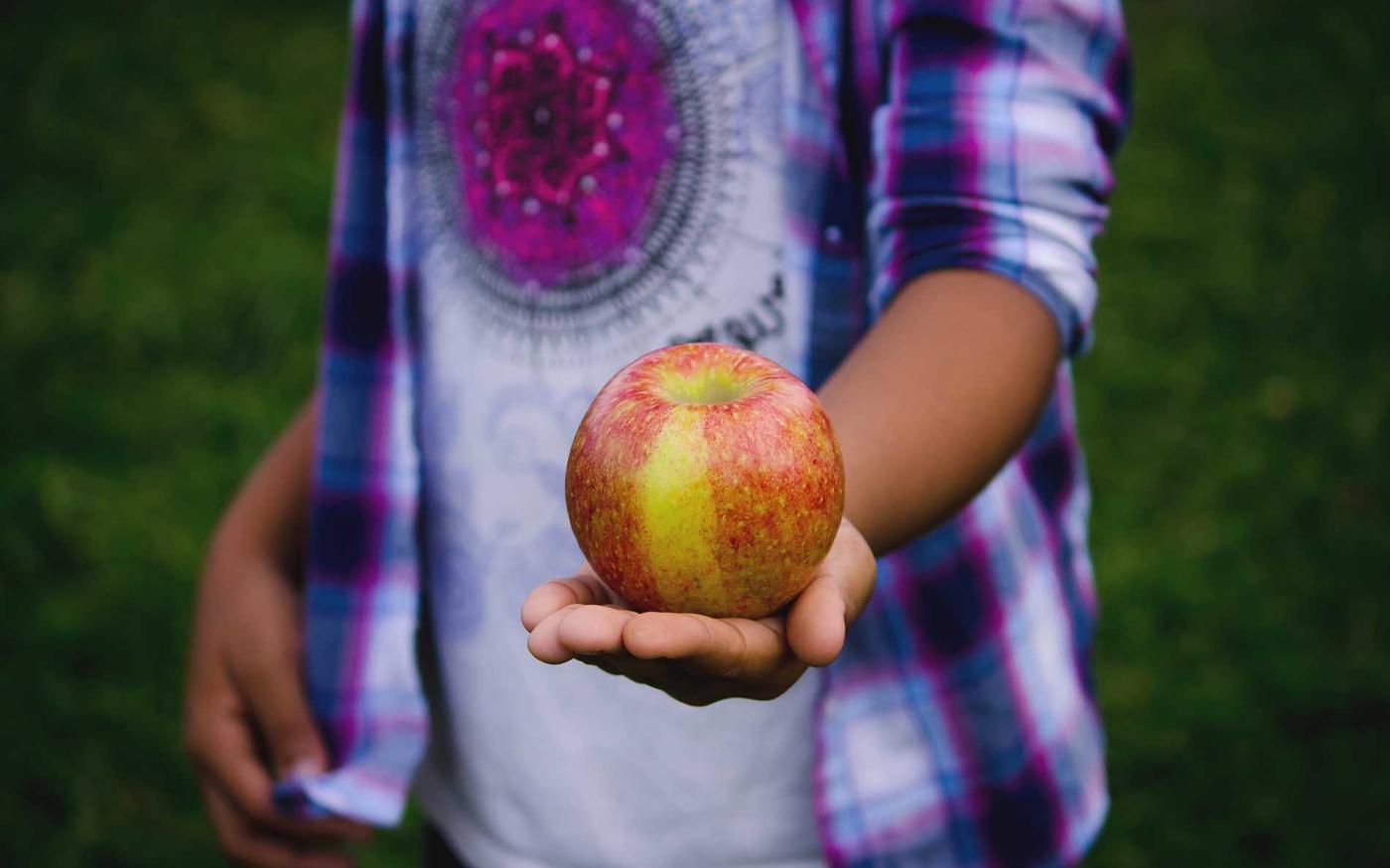 Giving an apple.